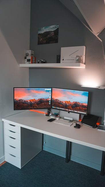 Corner desk setup with dual monitors
