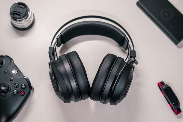 Gaming headset on a desk next to a controller